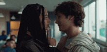 a man and a woman are looking into each other 's eyes and victor is visible in the corner