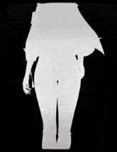 a woman is wearing a white shirt and black pants with a belt around her waist
