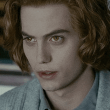 a close up of a young man with red hair