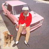 a man standing next to a pink car with pixverse.ai on the bottom right