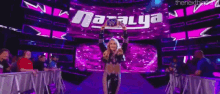 a woman is holding a women 's wrestling championship trophy