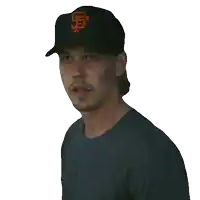 a man wearing a baseball cap with the letter g on it