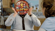 a man with a balloon that says lotto on it covering his face