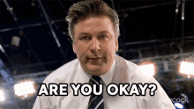 a man in a white shirt and tie is asking if he is okay