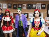 a group of women are dressed in costumes for halloween .