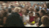 a blurry picture of a crowd of people including a man