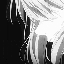 a close up of a person 's face with long white hair on a black background .