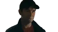 a man wearing a black baseball cap and a black jacket