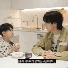 a man and a boy are sitting at a table with a clock on it that shows the time as 7:20