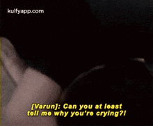 a man is talking to another man in a dark room and the man is asking him why he is crying .