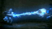 a blue lightning bolt is coming out of the ground in the dark