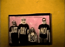 a picture of a group of people wearing black shirts that say just say no