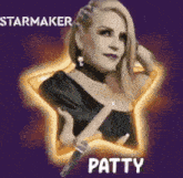 a woman is holding a microphone in front of a star shaped background .