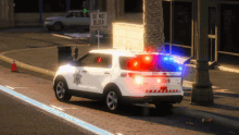 a police car is parked in front of a do not block sign