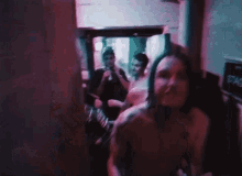 a man without a shirt is giving the middle finger to the camera