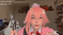 a girl with pink hair is holding a pair of scissors in her hands .