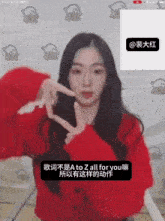 a woman wearing a red sweater is making a peace sign