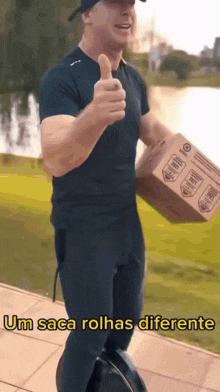 a man giving a thumbs up while holding a cardboard box that says ' um saca rolhas diferente ' on it