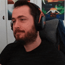 a man with a beard wearing headphones with the letter h on the top