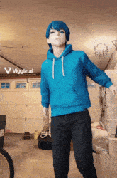 a mannequin wearing a blue hoodie is standing in a garage with a sign that says viggle.ai in the corner