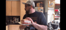 a man holding a plate with a piece of meat on it and a shirt that says stranger things