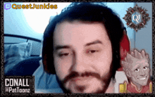 a man with a beard and headphones is on a questjunkies twitch channel