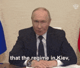 a man in a suit and tie is sitting at a desk and saying that the regime in kiev