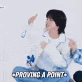 a person sitting on the floor with the words proving a point on the bottom