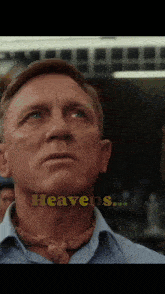 a close up of a man 's face with the word heavens written above him