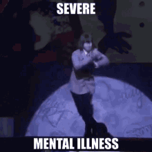 a man is dancing on a stage with the words " severe mental illness " on the bottom