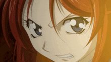 a close up of a girl with red hair and blue eyes making an angry face