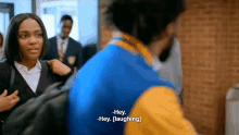a man in a blue jacket is laughing while talking to a girl