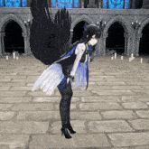 a girl with black wings is standing in front of a building