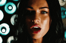 a close up of a woman 's face with red lipstick