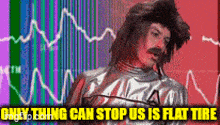 a man with a mustache is standing in front of a graph with the words `` only thing can stop us is flat tire '' .
