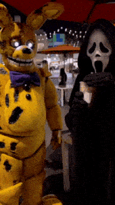 a grim reaper standing next to a yellow bunny