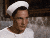 a man wearing a white beret and a white shirt