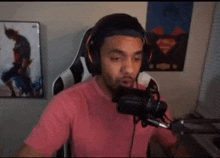 a man wearing headphones is talking into a microphone .