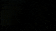 a blurred image of a person standing in front of a plane with the letters ns on it
