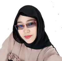a woman wearing glasses and a hijab looks at the camera