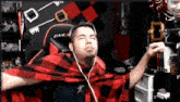 a man wearing headphones and a plaid shirt is sitting in front of a dxr chair