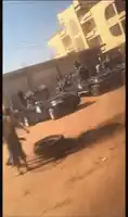 a bunch of cars are parked in a dirt lot