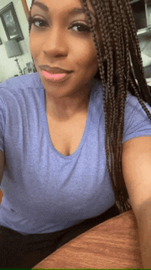 a woman with braids is taking a selfie