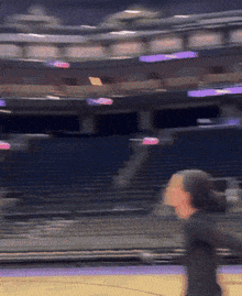 a blurry picture of a woman playing basketball in an arena