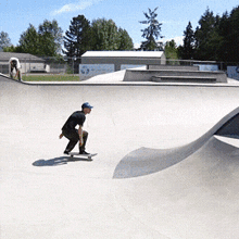 a man riding a skateboard in a skate park
