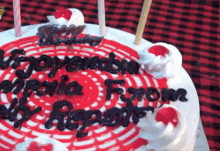 a red and white cake with the words " vijayendra " on it