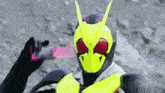a close up of a person wearing a mask and holding a sword .