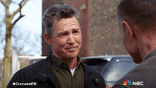a man talking to another man with #chicagopd written on the bottom of the image