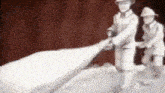 a statue of a fireman holding a hose with a red background