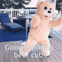 a teddy bear says good morning bear cubs while dancing on a deck